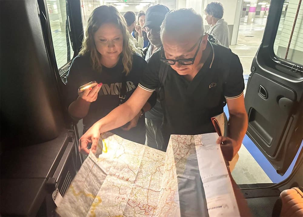 Two Globetrotter leaders navigating by paper map and a small light, with no GPS, during the self-guided Northern Portugal program